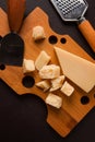 Hard cheese, parmesan, on a cutting board, cheese knife, grater, top view, no people, Royalty Free Stock Photo