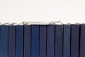 Hard cover books,encyclopedia series lined up on white background