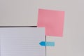 Upper view striped lined hard cover note book blank color sticky note arrow banner inserted clear background. Reminder Royalty Free Stock Photo