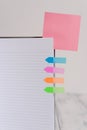 Upper view striped lined hard cover note book blank color sticky note arrow banners inserted clear background. Reminder Royalty Free Stock Photo