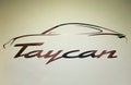 The hard cover of a Porsche Taycan all-electric sedan promotional booklet