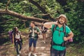 Hard, difficult, tiring and exhausting expedition of four friends in wild forest in trail. Guy is struggling of a neck pain, massa