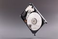 Hard disk drive HDD with open top cover on gray background Royalty Free Stock Photo