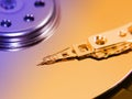 Hard disk drive inside, toned, closeup magnetic head and disk surface Royalty Free Stock Photo