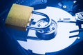 Hard disk drive plate with a padlock on it. Internet data privacy information cyber crime security concept. Blue toned image Royalty Free Stock Photo