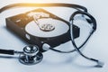 Hard disk drive and stethoscope. HDD diagnostic and repair Royalty Free Stock Photo