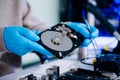 Hard disk drive on the technician's desk and a computer motherboard as a component. the concept of data, hardware, and Royalty Free Stock Photo