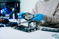 Hard disk drive on the technician's desk and a computer motherboard as a component. the concept of data, hardware, and Royalty Free Stock Photo