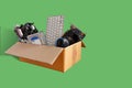 Hard disks and motherboards and old computer hardware accessories, Electronic waste in paper boxes isolated on green background, Royalty Free Stock Photo