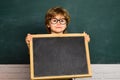 Hard exam. Elementary school and education. Preschooler. Blackboard copy space. Little children at school lesson Royalty Free Stock Photo