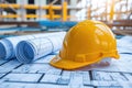 A hard hat and blueprints neatly organized on a table, showcasing the essential tools and plans required for construction projects Royalty Free Stock Photo