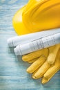 Hard hat construction plans protective gloves on wooden board bu Royalty Free Stock Photo