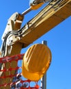 Hard hat on the road construction site and an excavator Royalty Free Stock Photo