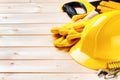 Hard hat and various tools on wooden background Royalty Free Stock Photo