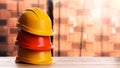 Hard hats on wooden surface near pallets with red bricks. Space for text Royalty Free Stock Photo