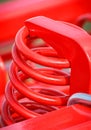 Hard red spring made of steel. Part and detail of industrial or agricultural machine Royalty Free Stock Photo