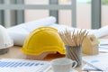 Hard safety helmet hats, construction equipment, blueprint on the table in conference office worker, architect working desk.