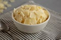 Hard Shaved Parmesan Cheese in a Bowl, side view. Close-up Royalty Free Stock Photo
