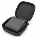 Hard-shell black zipper case with an open lid and a folded gray fabric item inside. The Royalty Free Stock Photo