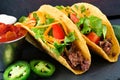Hard shelled tacos with beef, lettuce, tomatoes and cheese close-up Royalty Free Stock Photo