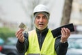 Bad times: poor construction worker and his empty wallet Royalty Free Stock Photo