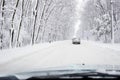 Hard winter traffic with car on snow coverd road Royalty Free Stock Photo