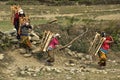 Village in the vicinity of Pokhara. Peasant women carry firewood