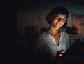 Hard work gets you where you want. a young businesswoman using a digital tablet during a late night at work.