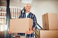 Hard work got him the home of his dreams. a handsome mature man carrying a box on moving day. Royalty Free Stock Photo