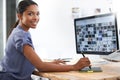 Hard work pays off. a young african american woman working at her computer in the office. Royalty Free Stock Photo