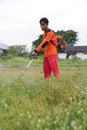 Hard worker asian people cutting the grass