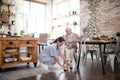 Hard-working caregiver lacing shoes for aged woman