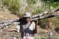 Hard working man carrying a tree trunk - MADAGASCAR Royalty Free Stock Photo