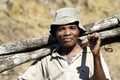 Hard working man carrying a tree trunk - MADAGASCAR Royalty Free Stock Photo