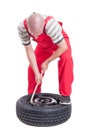 Hard-working mechanic changing car wheel tire Royalty Free Stock Photo