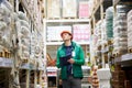 Hard working warehouse worker look up on commodity Royalty Free Stock Photo