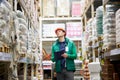 Hard working warehouse worker look up on commodity Royalty Free Stock Photo