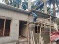 A hard working worker is building a house in india