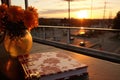 a hardcover journal on a balcony railing during sunset