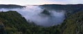 Hardegg medieval castle on a fortified hill upon Thaya river during summer or autumn time. Misty big ruins in the Thayatal Valley.