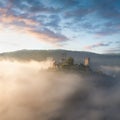 Hardegg medieval castle on a fortified hill upon Thaya river during summer or autumn time. Misty big ruins in the Thayatal Valley.