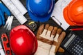 Hardhat, gloves and blueprints of a builder Royalty Free Stock Photo