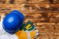 Hardhat, gloves and blueprints of a builder Royalty Free Stock Photo