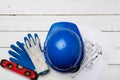 Hardhat, gloves and blueprints of a builder Royalty Free Stock Photo