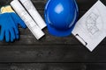 Hardhat, gloves and blueprints of a builder Royalty Free Stock Photo