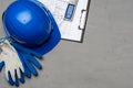 Hardhat, gloves and blueprints of a builder Royalty Free Stock Photo