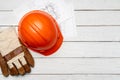 Hardhat, gloves and blueprints of a builder Royalty Free Stock Photo