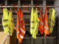 Yellow work vests are hanging on a hanger