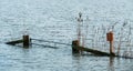 Hardinxveld, Netherlands - 2018-01-14: Gate with reeds and sign in flooded river forelands