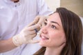 Hardware cosmetology, mesotherapy, Close up of young woman getting treatment of cheek zone at spa Royalty Free Stock Photo